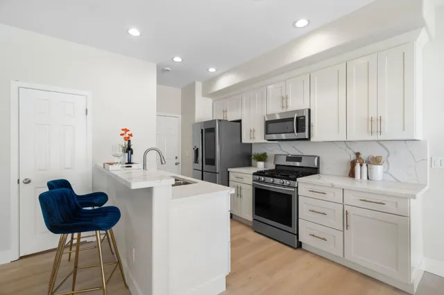 a kitchen with appliances cabinets and a sink