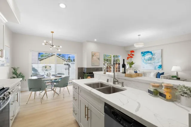 a kitchen with a sink a stove and chairs