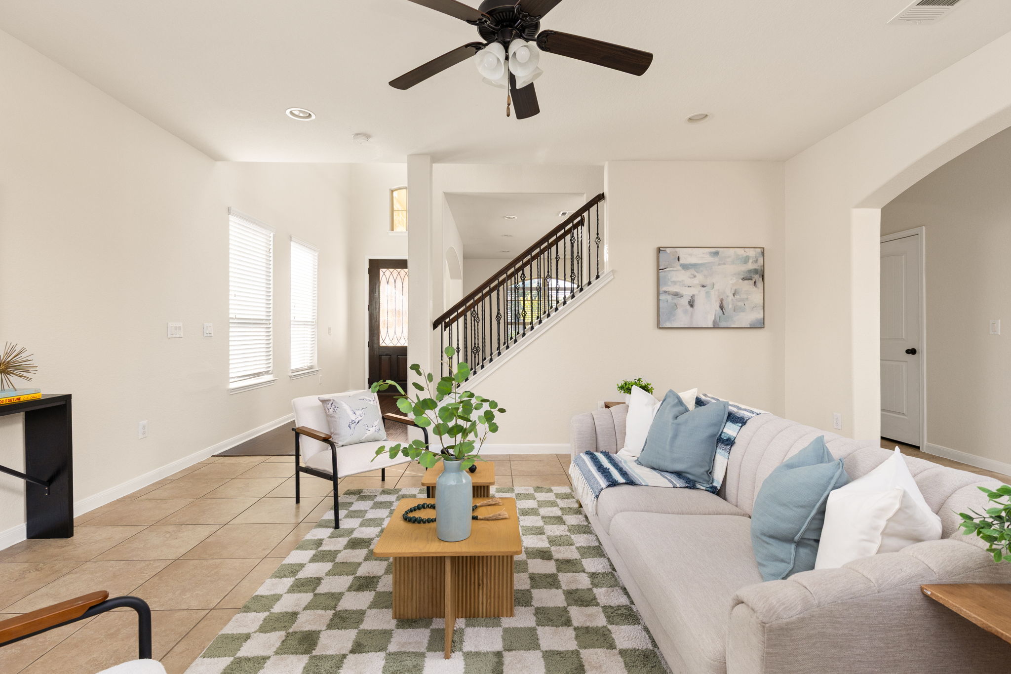 2400 Leonards Pass Leander, TX 78641 - Photo 11 of 40 A welcoming living area showcases a beautiful staircase and durable tile flooring.