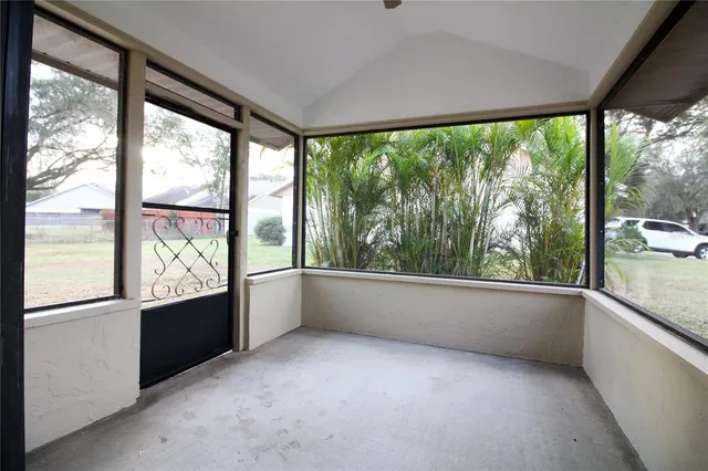 an empty room with large windows