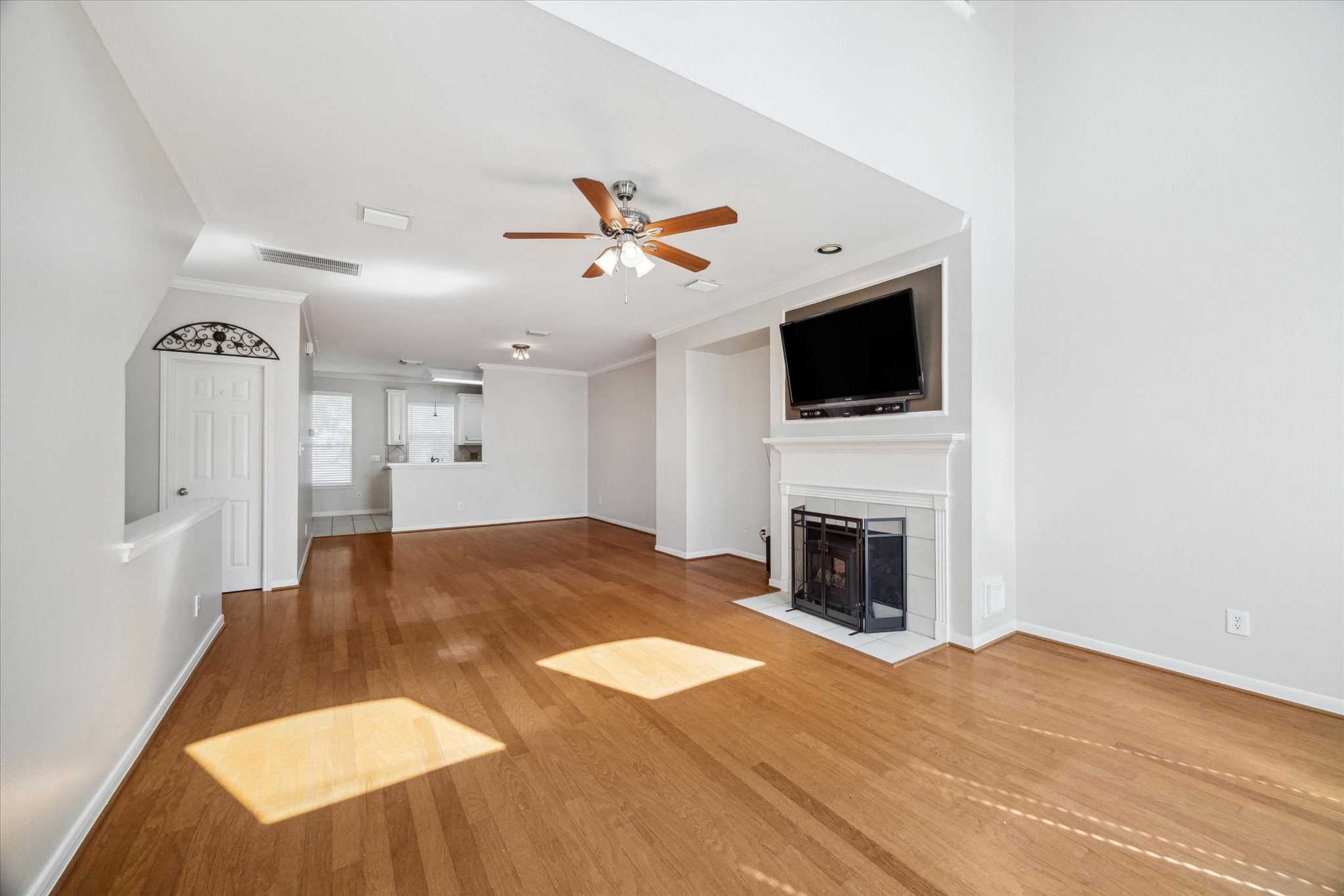 1639 Sutton Street Houston, TX 77006 - Photo 7 of 27 a living room with a fireplace and a flat screen tv