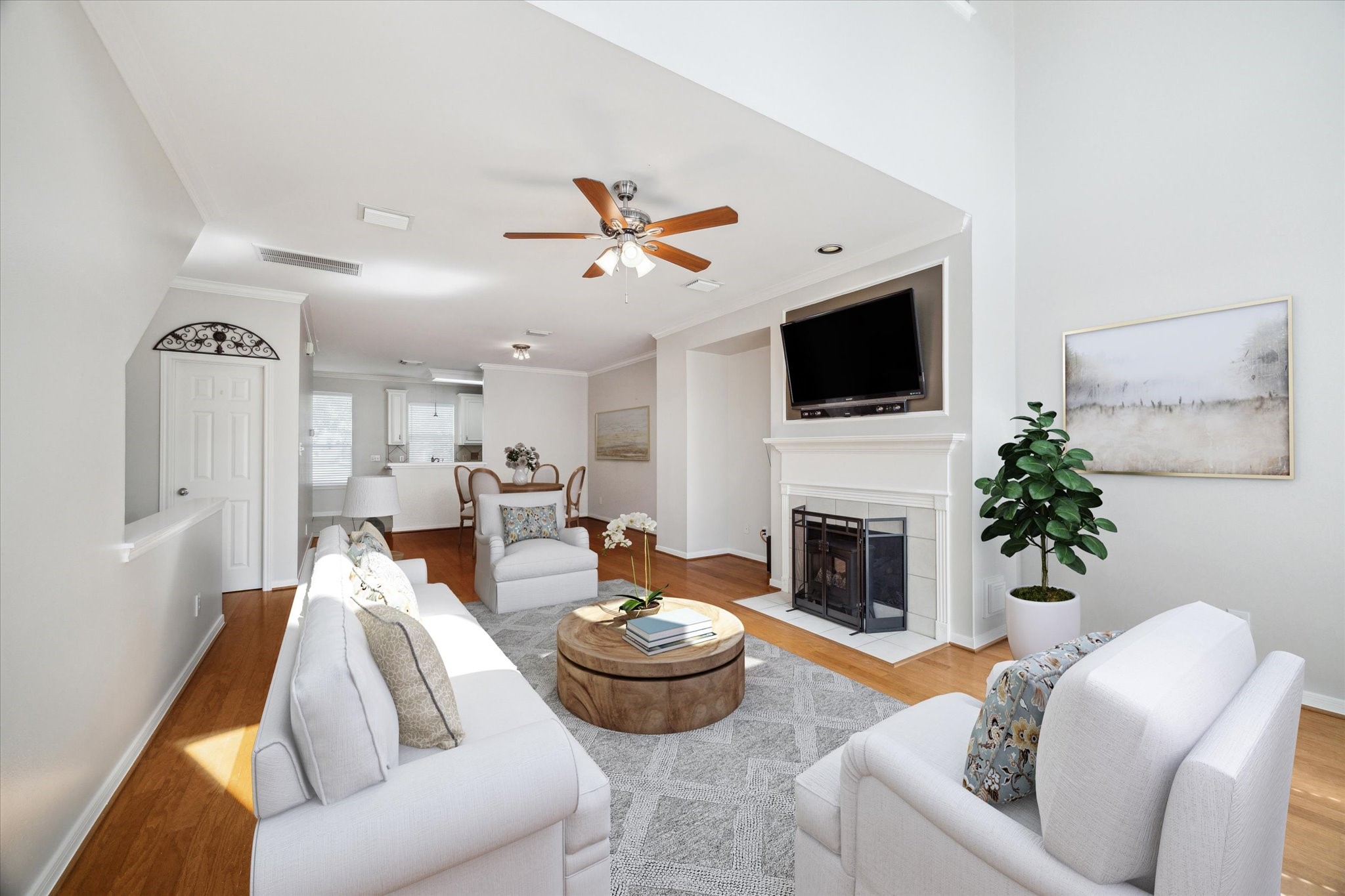1639 Sutton Street Houston, TX 77006 - Photo 8 of 27 a living room with furniture a fireplace and a flat screen tv
