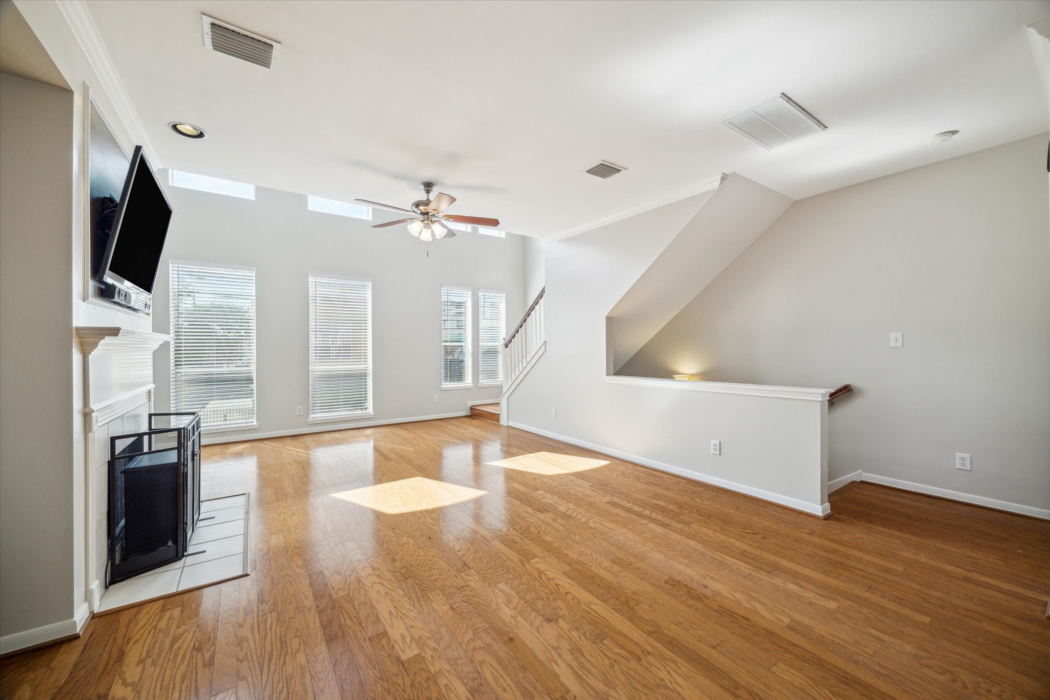 1639 Sutton Street Houston, TX 77006 - Photo 9 of 27 a view of a livingroom with wooden floor and a kitchen