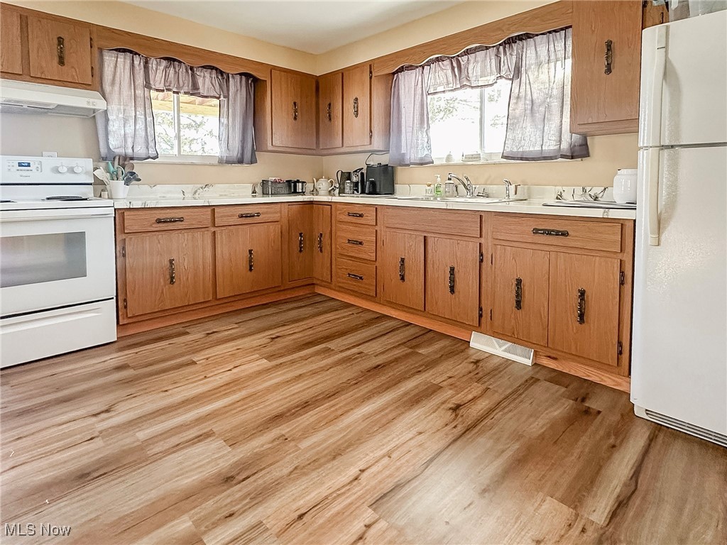 461 Tr 376 Road Toronto, OH 43964 - Photo 8 of 35 Kitchen featuring white appliances, light hardwood / wood-style floors, and sink
