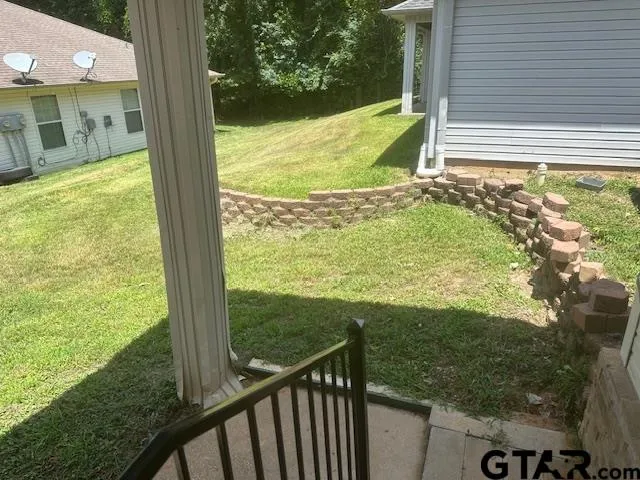 a view of a balcony next to a yard