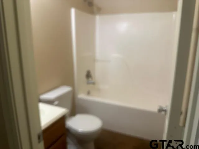 a bathroom with a toilet and a bathtub