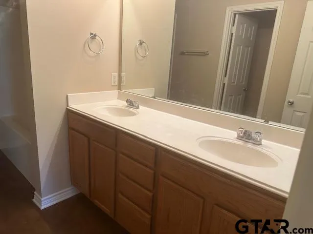 a bathroom with a double vanity sink and a mirror