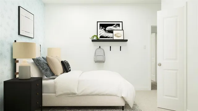 a bedroom with a bed and painting on the wall