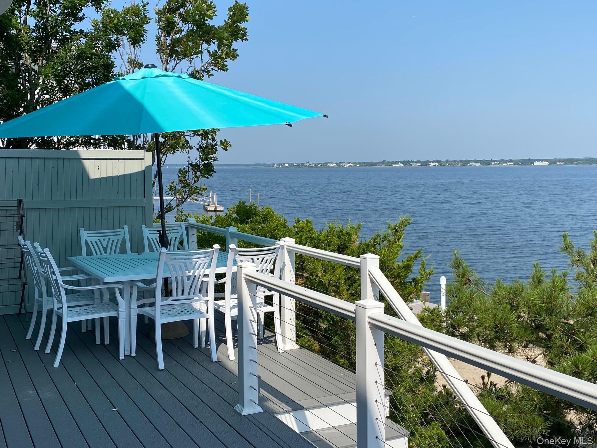 88 Point Road Westhampton Beach, NY 11978 - Photo 1 of 16 a view of a chairs and table on the deck