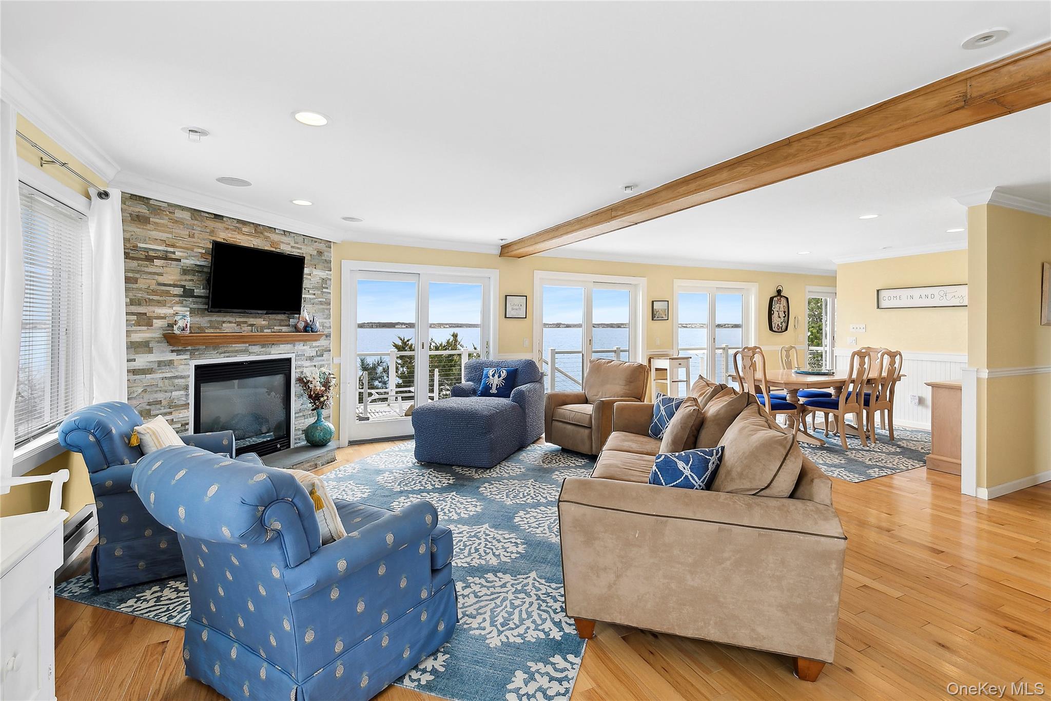 88 Point Road Westhampton Beach, NY 11978 - Photo 3 of 16 a living room with furniture a fireplace and a flat screen tv