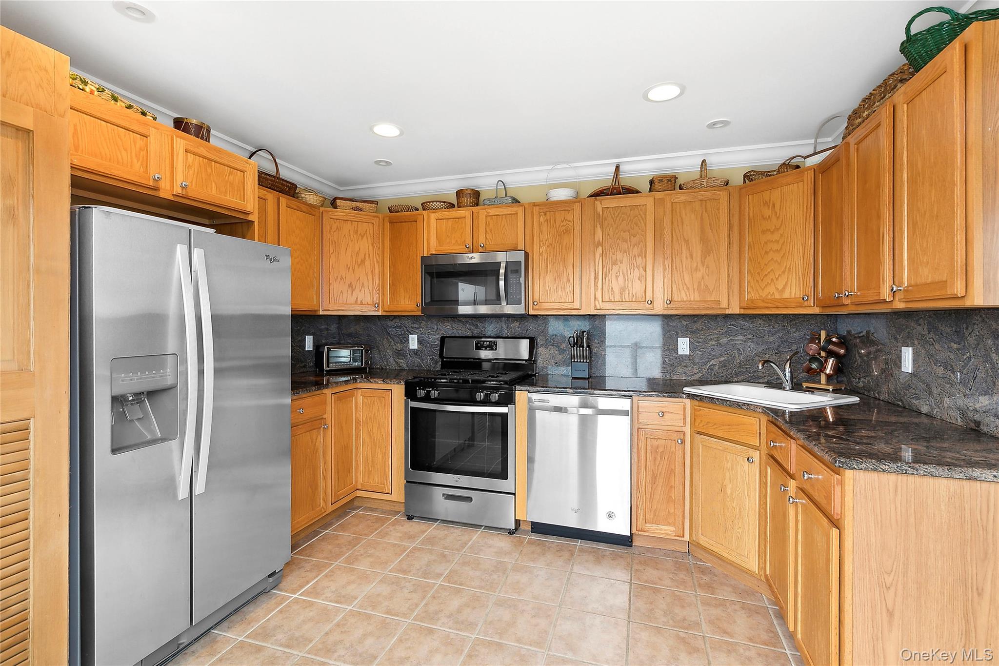 88 Point Road Westhampton Beach, NY 11978 - Photo 5 of 16 a kitchen with stainless steel appliances granite countertop a refrigerator stove top oven and sink