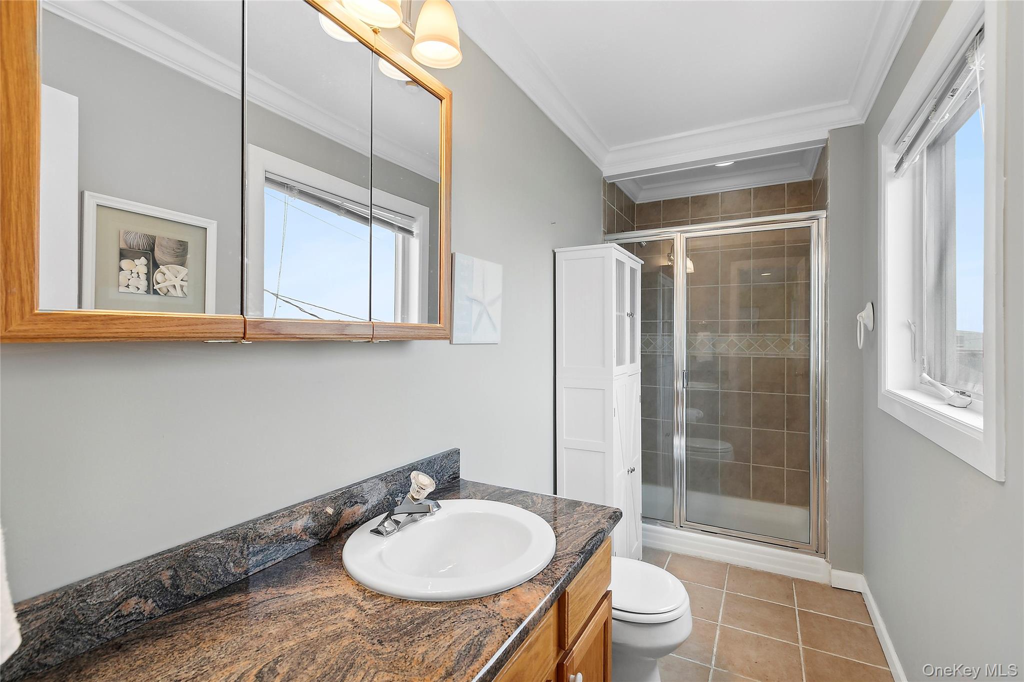 88 Point Road Westhampton Beach, NY 11978 - Photo 9 of 16 a bathroom with a sink toilet a mirror and shower