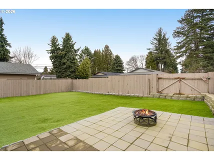 a view of backyard with swimming pool and outdoor seating