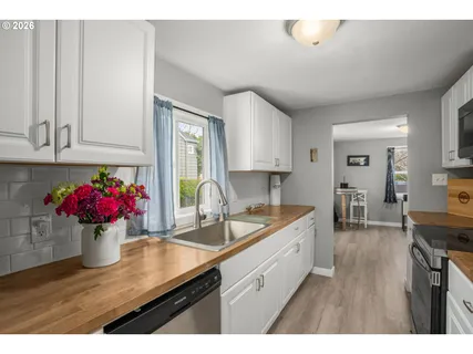 a kitchen with a sink cabinets and wooden floor