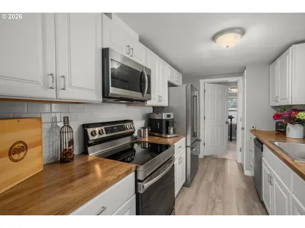 a kitchen with kitchen island granite countertop a stove and a sink