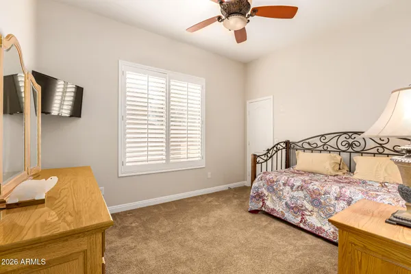 a room with a bed and a television