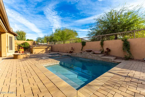 a view of a patio with swimming pool table and chairs