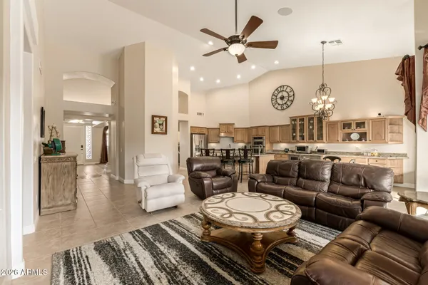 a living room with lots of furniture and view of kitchen