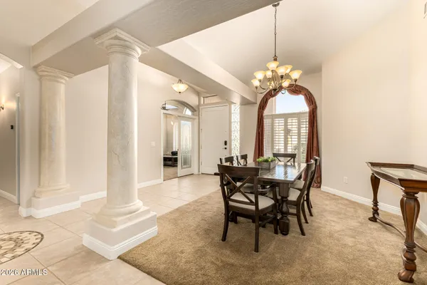 a view of a dining room with furniture and chandelier