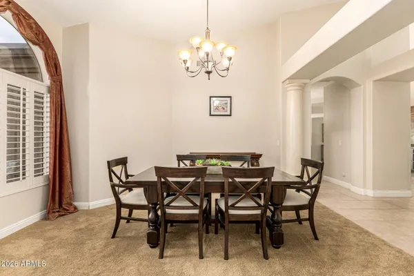a view of a dining room with furniture and chandelier