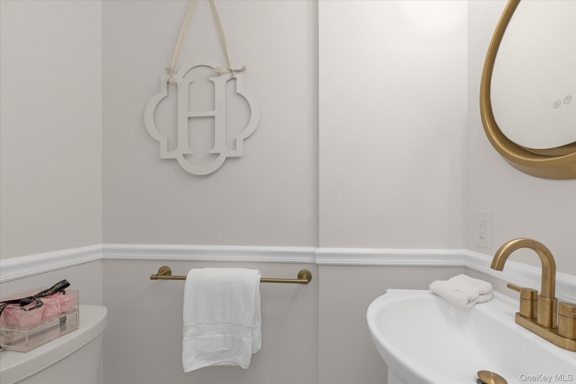 830 Shore Road, Unit 1F Long Beach, NY 11561 - Photo 13 of 21 a bathroom with a sink and a mirror