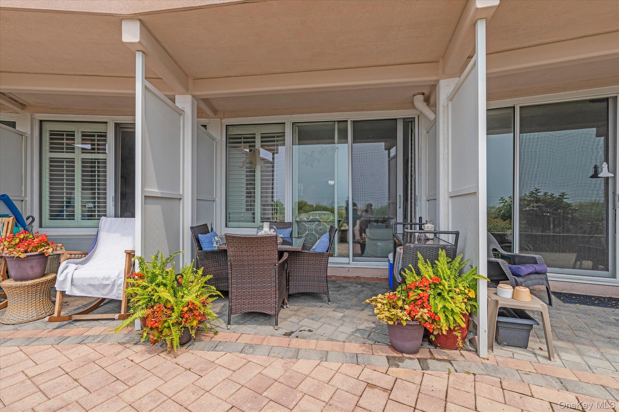 830 Shore Road, Unit 1F Long Beach, NY 11561 - Photo 14 of 21 a outdoor space with chairs and a couch