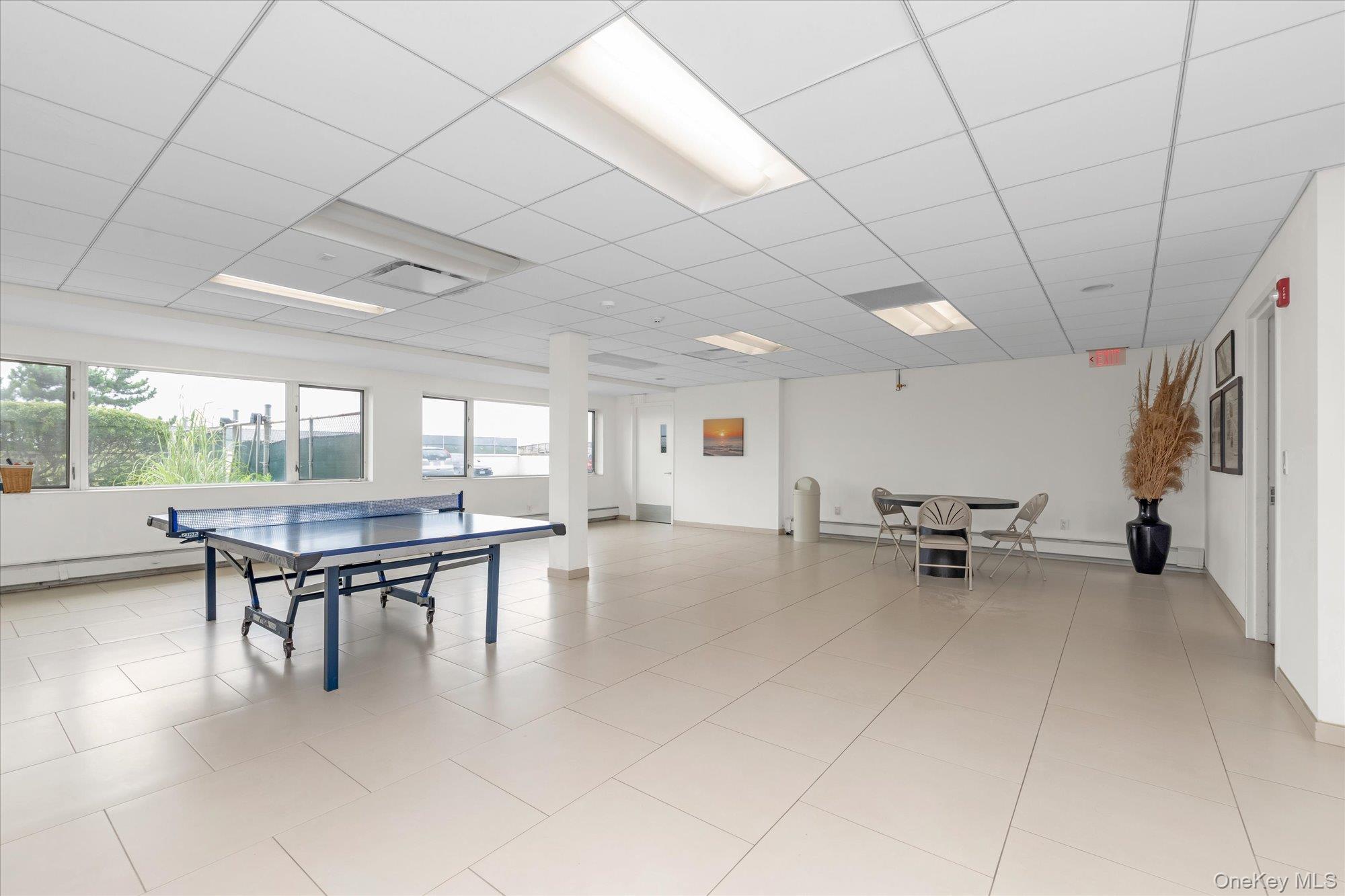 830 Shore Road, Unit 1F Long Beach, NY 11561 - Photo 18 of 21 a dining room with furniture and a floor to ceiling window