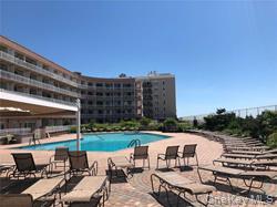 830 Shore Road, Unit 1F Long Beach, NY 11561 - Photo 20 of 21 a view of a patio with chairs and table
