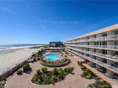 830 Shore Road, Unit 1F Long Beach, NY 11561 - Photo 21 of 21 a view of a swimming pool with an ocean