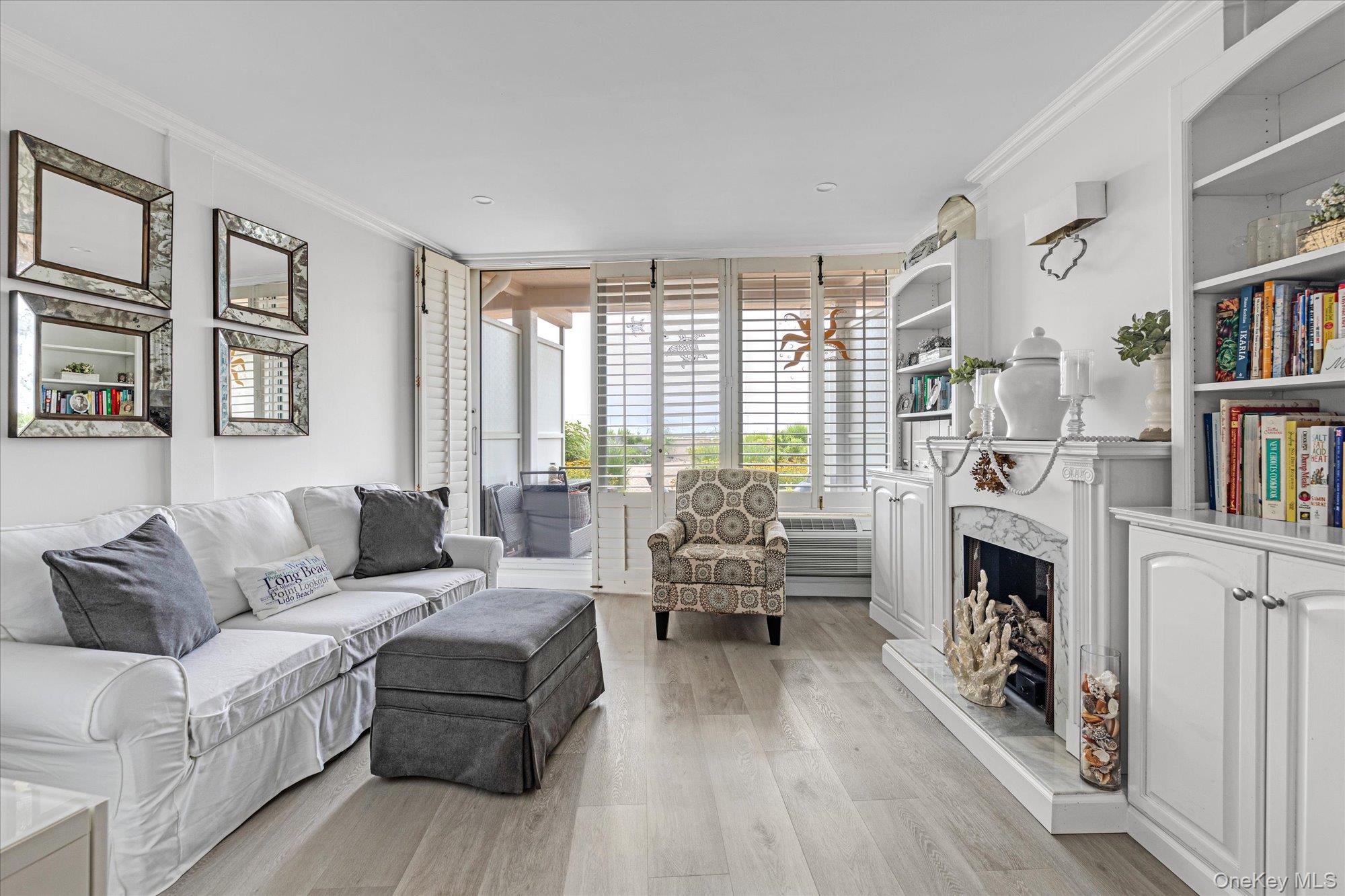 830 Shore Road, Unit 1F Long Beach, NY 11561 - Photo 8 of 21 a living room with furniture large window and book shelf