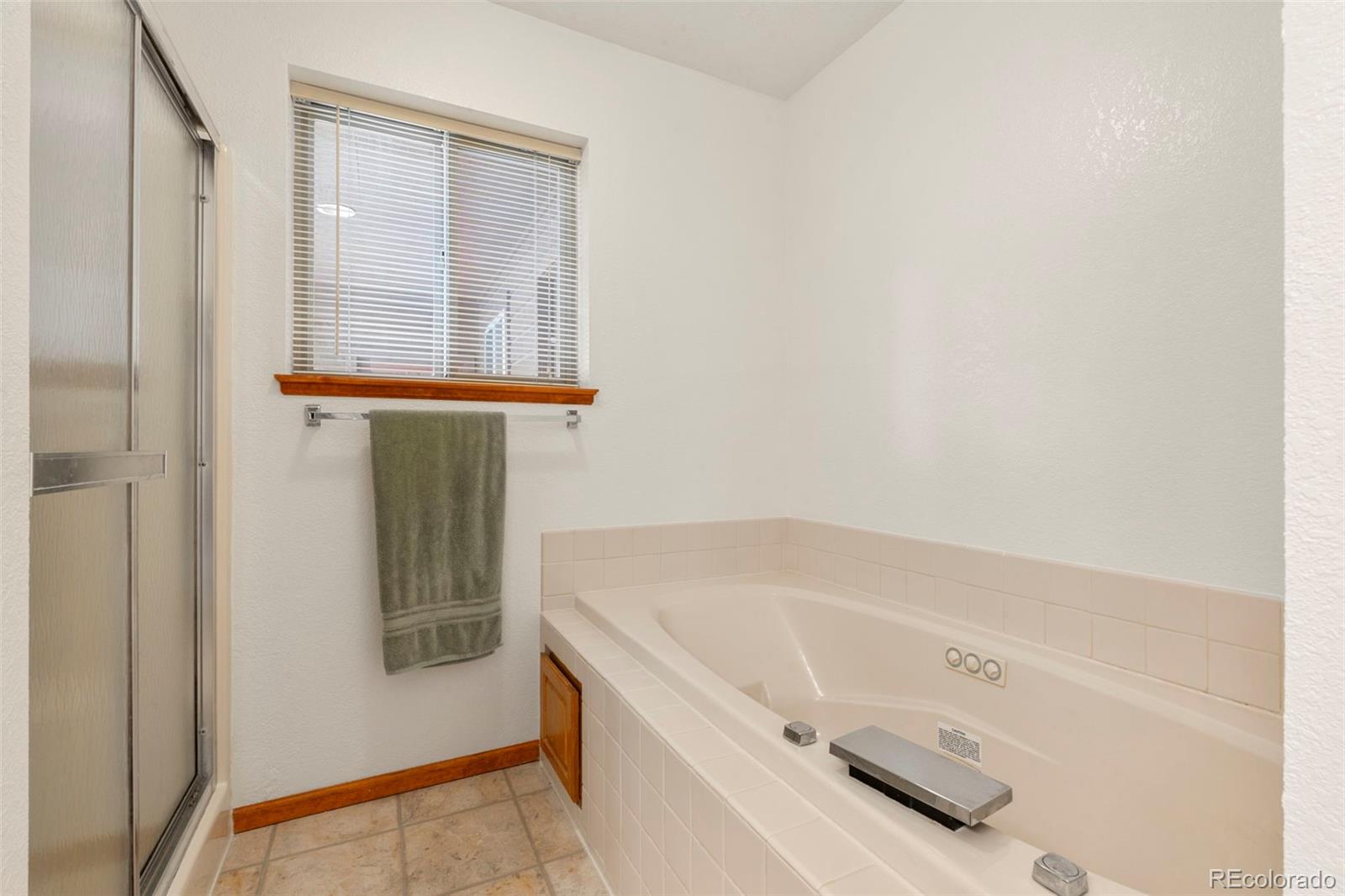 84 Marys Lane Bailey, CO 80421 - Photo 24 of 35 a bathroom with a tub sink and mirror