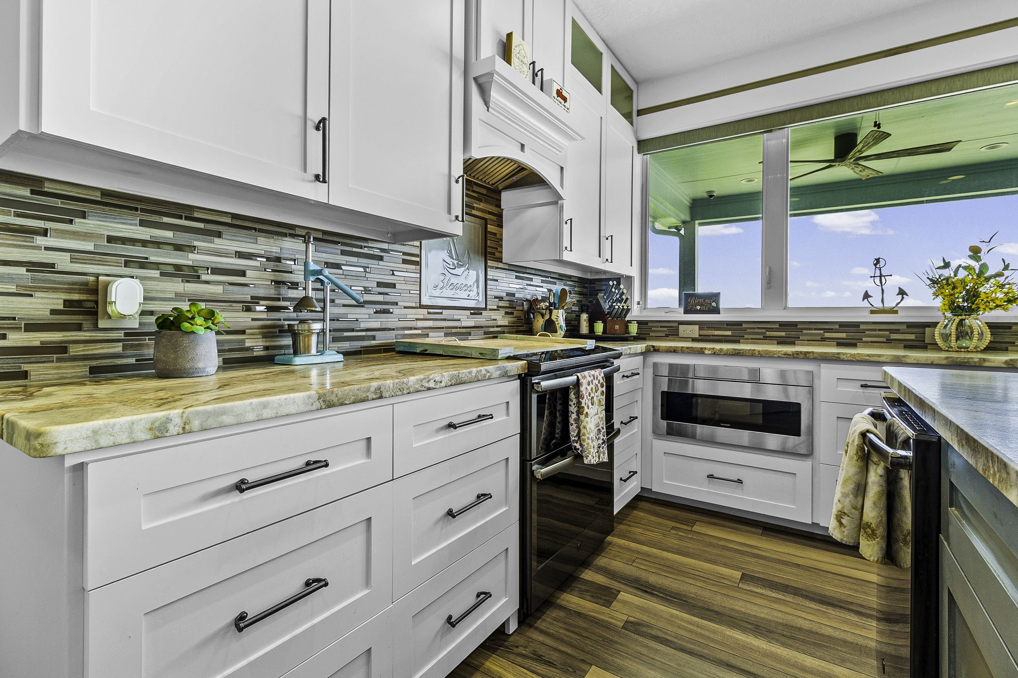 151 Key Largo Loop Point Blank, TX 77364 - Photo 13 of 49 Marble countertops, custom cabinetry, and a stylish tile backsplash combine with lake views to create a dream kitchen.