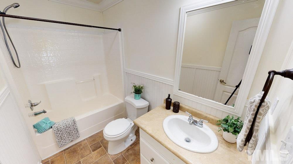 351 Wilson Road Lucama, NC 27851 - Photo 22 of 29 a bath room with a toilet a sink and a bath tub