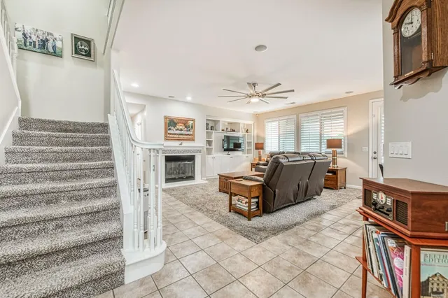 a living room with furniture and a ceiling fan
