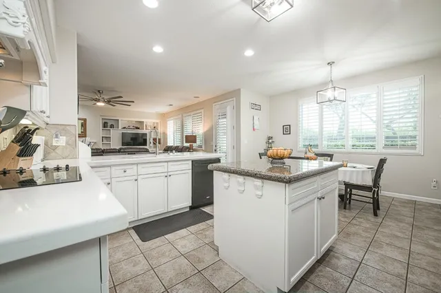 a bedroom with a bed a dresser and a window