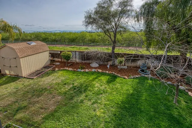 an aerial view of a house with outdoor space and lake view
