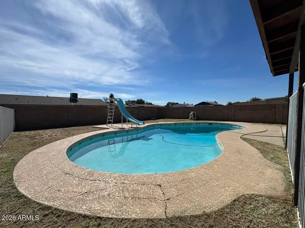 a view of a swimming pool with a yard and mountain view