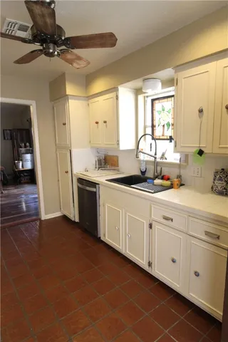 a kitchen with a sink cabinets and window