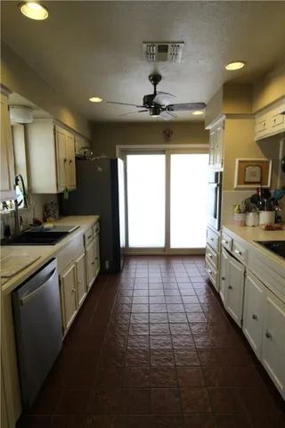 a kitchen with a sink stainless steel appliances and cabinets