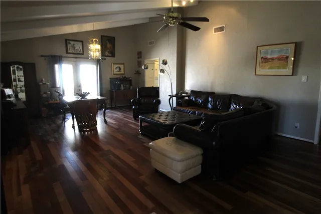 a living room with furniture and wooden floor