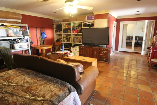 a living room with patio furniture and a flat screen tv