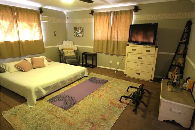 a bedroom with a bed and flat screen tv