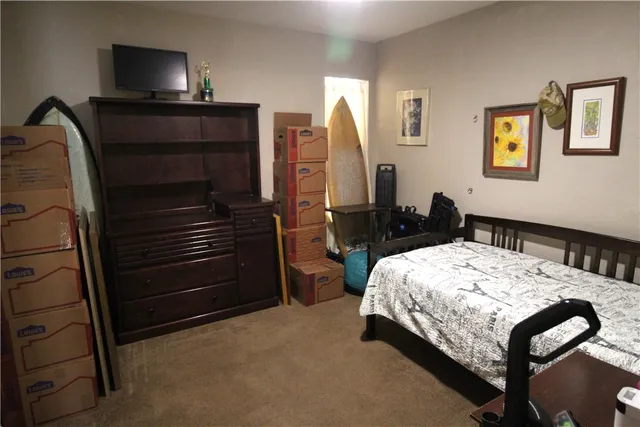 a bedroom with a bed and a dresser