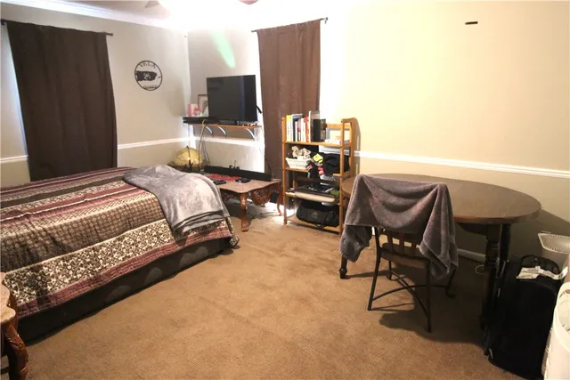 a bedroom with furniture and a flat screen tv