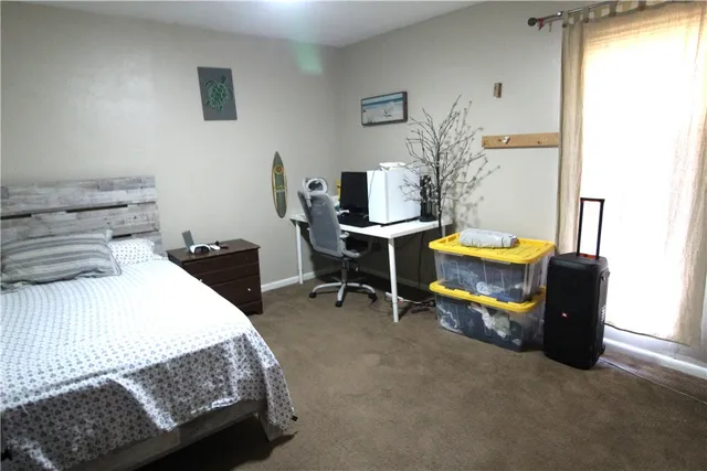 a bedroom with a bed and a desk