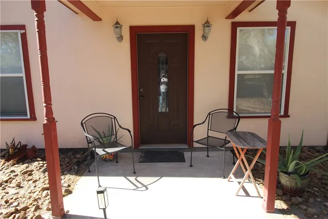 a room with two chandeliers and gym equipment