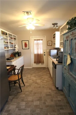 a kitchen with granite countertop a sink stove and cabinets