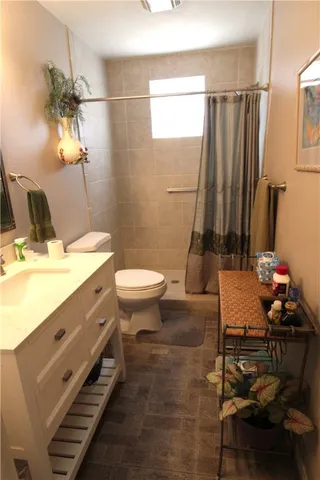 a bathroom with a sink mirror vanity and toilet
