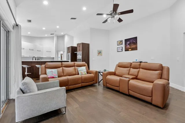 a outdoor living space with furniture and a black umbrella