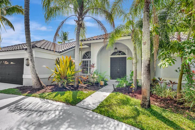 a kitchen with granite countertop a stove a sink and a refrigerator